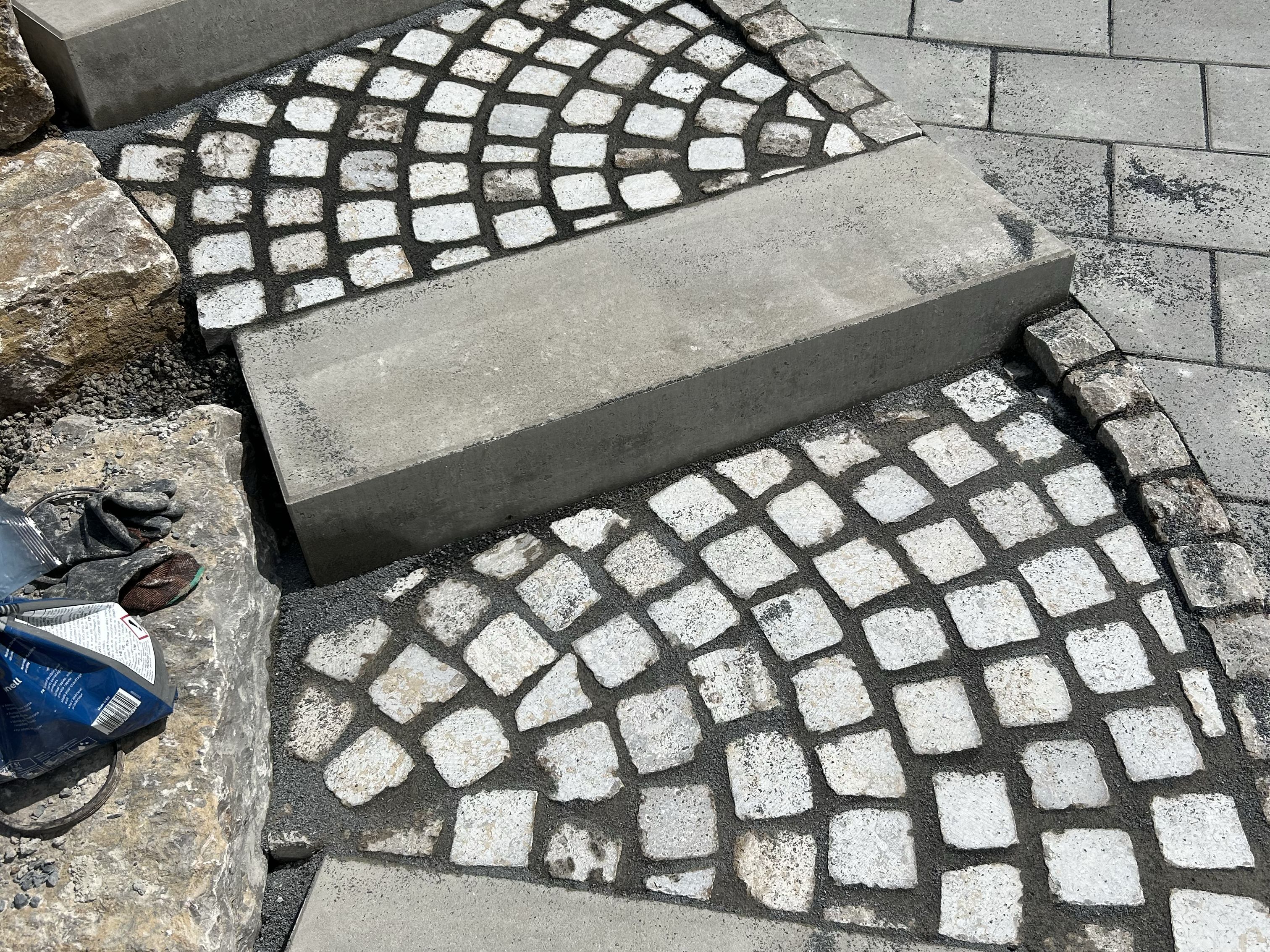 Kombination aus Betonstufen und Natursteinpflaster